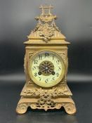 An ornate brass and enamel eight day mantle clock