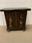 An oak two door cabinet with carved medieval style figures (H72cm W75cm D36cm)