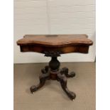 A walnut serpentine card table on a lobed baluster column and four down swept legs AF (H76cm W90cm