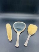 A Selection of three white metal backed dressing table brushes