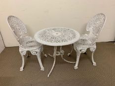 A white wrought iron garden table and chairs