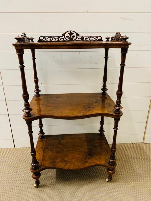 A Regency style three tier whatnot with scroll detailing to back