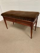 A 20th century mahogany duet piano stool with storage