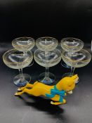 A Set of Six Babycham Glasses along with a Babycham Advertising Figure