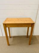 A pine desk with hinged lid (H76cm W73cm D40cm)