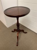 A mahogany wine table on tripod feet