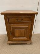 A bedside cabinet with drawer