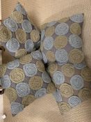 A selection of four Malini Grey cushions with wool circular design to front