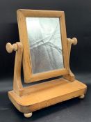 A small wooden table top mirror