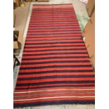 A large red, blue and white rug