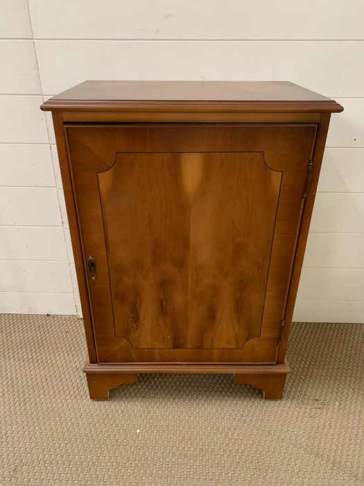 A cabinet with adjustable shelf and key