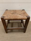 A small stool with a rattan seat