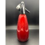 A vintage Sparklets BOC soda syphon red bottle