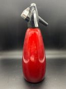 A vintage Sparklets BOC soda syphon red bottle