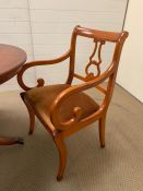 A regency style mahogany dining table with brass lion claw feet, with four chairs and two carvers (