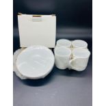 Set of four boxed white espresso cups and saucers