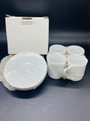 Set of four boxed white espresso cups and saucers