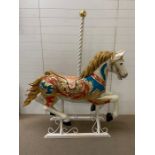 A carousel horse decorated with gilt flowers (H160cm W146cm D50cm)