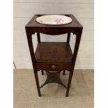A mahogany washstand, three circular fittings with bowl to one (H79cm W32cm)