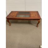 Walnut veneer coffee table with two smoked glass centre panels