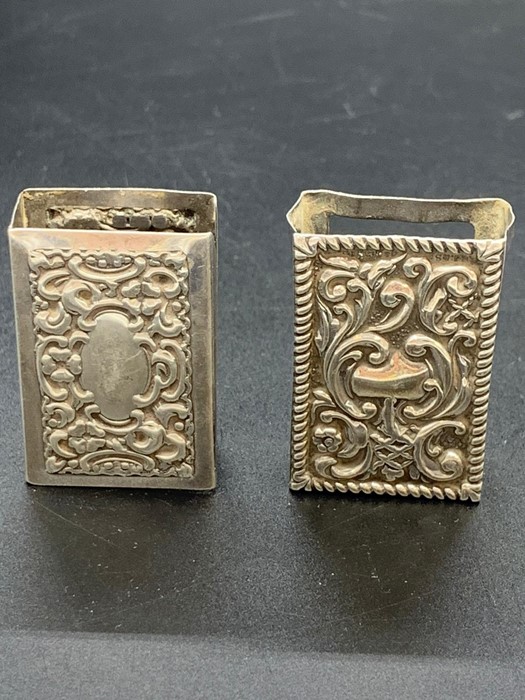 Two silver matchbox holders.