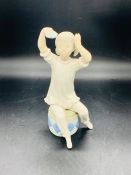 A Lladro figure of a girl seated on a drum