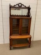 A mahogany waterfall display case with mirrored back