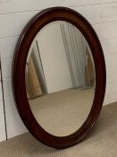 A mahogany oval mirror
