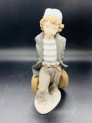 A Lladro figure of a girl with baskets
