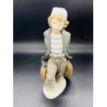 A Lladro figure of a girl with baskets