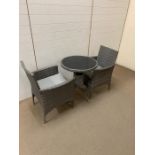 A garden Bistro set of a rattan grey chairs and table (H75cm)