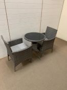 A garden Bistro set of a rattan grey chairs and table (H75cm)