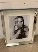 A black and white print of Paul Newman in a mirrored frame