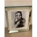 A black and white print of Paul Newman in a mirrored frame