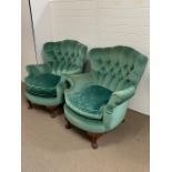 Pair of upholstered armchairs curved button back of a mid century design