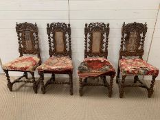 Four Jacobean style dining chairs, caned central back panel with carved cherubs and angels