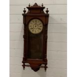 A wall clock in a mahogany case