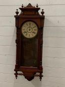 A wall clock in a mahogany case