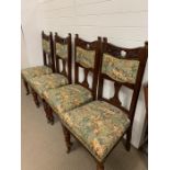 Four carved dining chairs with upholstered seats