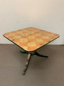 A Tilt Top Table decorated in gold and bronze leaf in a chess board or checker board pattern.