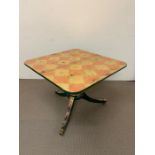 A Tilt Top Table decorated in gold and bronze leaf in a chess board or checker board pattern.