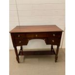 A mahogany sideboard with an assortment of five drawers (H78cm W96cm D47cm)