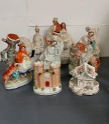 Seven Staffordshire flatbacks including spill vases and other figures