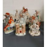 Seven Staffordshire flatbacks including spill vases and other figures