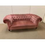 Large two seater pink Chesterfield sofa. (H75cm D90cm W190cm)