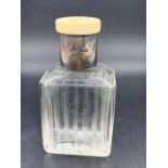 A Gents Dressing Table Bottle with hallmarked silver collar and ivory top