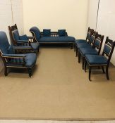 A Salon suite comprising Chaise Longue, two armchairs and four chairs, on castors in a blue fabric.