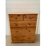 A pine two over three chest of drawers (H97cm W80cm D44cm)