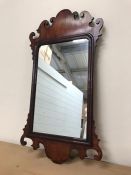 Two gilt oval wall mirrors and one mahogany framed wall mirror