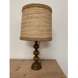 A brass and wooden table lamp